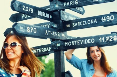 people in front of a sign with destinations