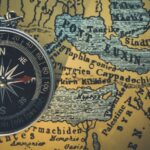 compass on an antique map of the world